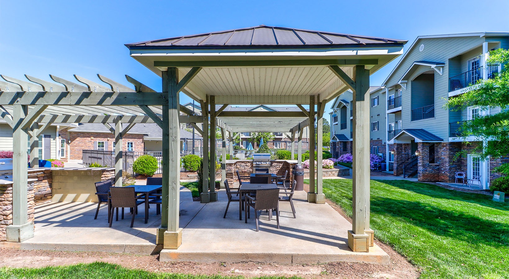 a bbq area with ample seating  at The Pointe at Heritage in Wake Forest, NC
