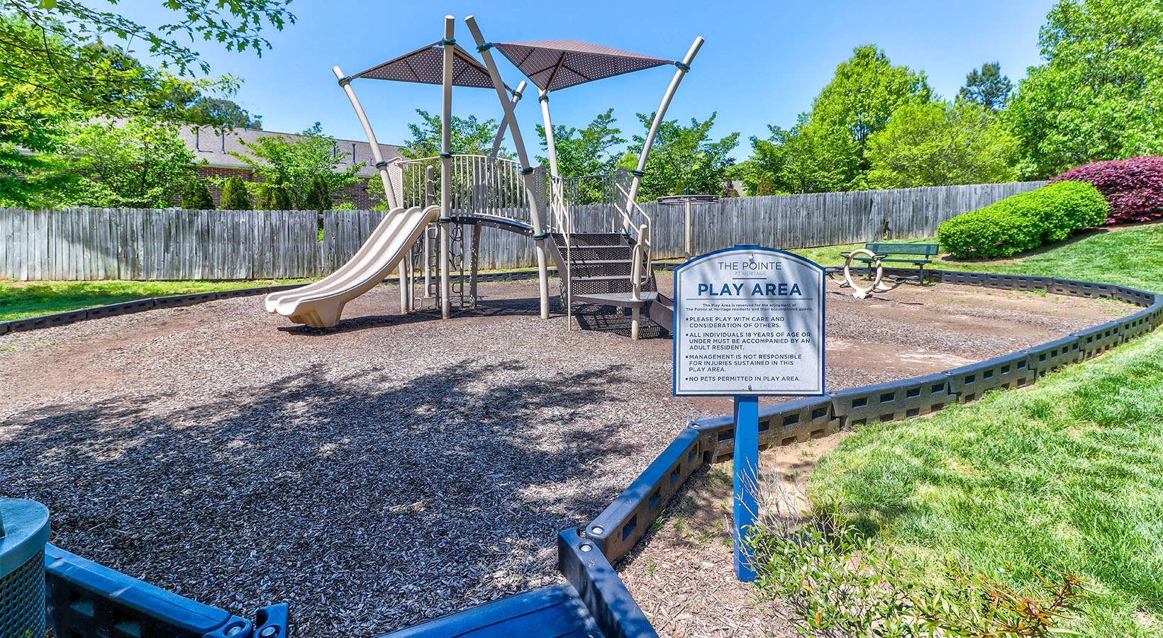 a playground with a slide at The Pointe at Heritage in Wake Forest, NC