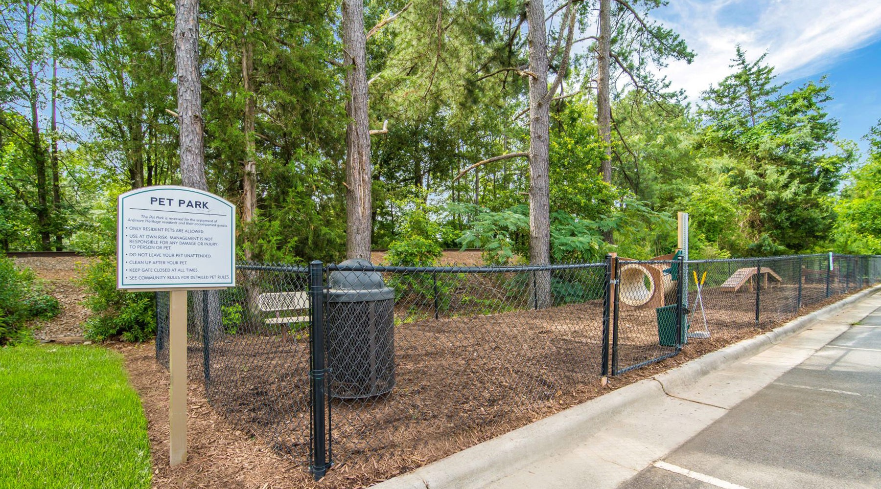 fenced in dog park with trees